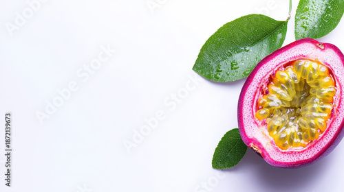 Vibrant slice of juicy purple passion fruit reveals its bright yellow seeds, surrounded by fresh green leaves, evoking sense of tropical delight