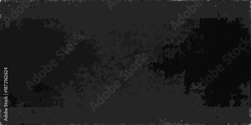 A predominantly black abstract image with textured and mottled areas