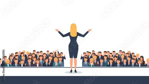 A confident blonde woman stands on a stage with her arms outstretched, addressing a large, attentive audience of diverse professionals.