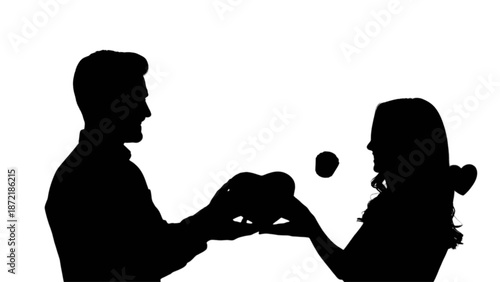 A loving couple shares hearts, symbolizing affection and romance in a beautiful silhouette