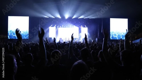 Wallpaper Mural Crowd of people enjoying a live music concert with bright stage lights and screens. Torontodigital.ca