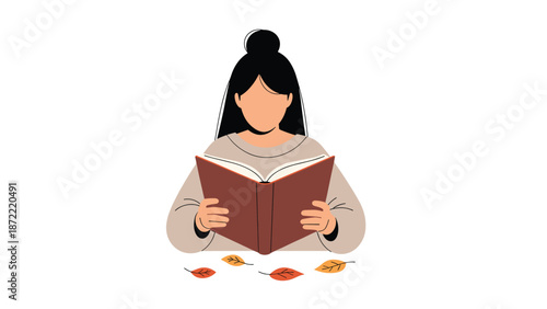 Woman with her hair in a bun reading a book with scattered autumn leaves at the bottom of the frame, showing a cozy fall activity.