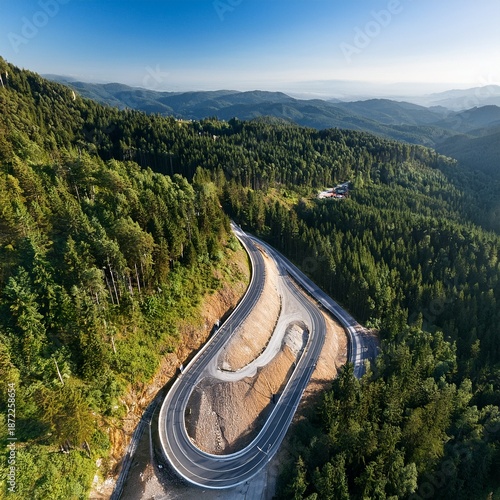 Aerial View of Scenic Winding Mountain Road Through Dense Green Forest, Curved Highway Landscape in Summer Nature, Drone Photography of Serpentine Road in Hills, Travel and Transportation Concept