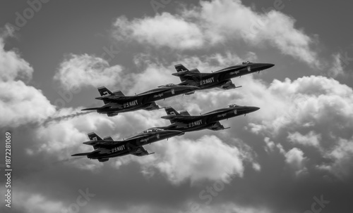 Naval Airshow, F-18 Super Hornet jets flying in formation on beautiful summer day high in the clouds