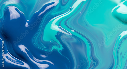 A mesmerizing closeup of swirling blue and turquoise paint creates an abstract and fluid texture, perfect for backgrounds, wallpapers, or artistic projects, showcasing the beauty of color mixing and m