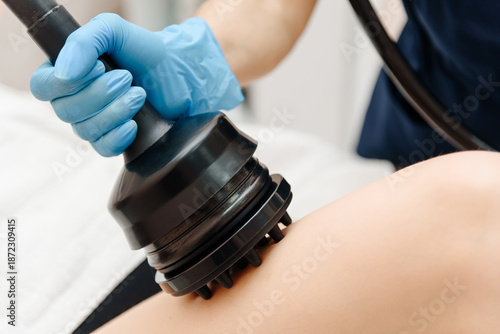 Photography RF lifting procedure with professional equipment in beauty salon, body massage f