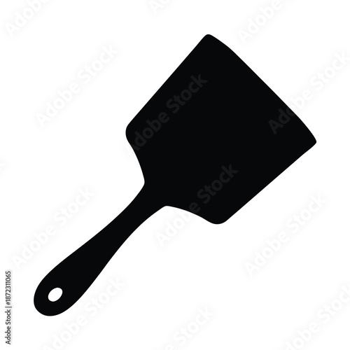Black silhouette of a kitchen spatula utensil with ergonomic handle and hanging hole