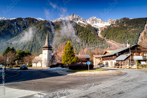 Mountain town of Les Praz de Chamonix with church and high peaks of Alps, Chamonix-Mont-Blanc, French village landscape.
