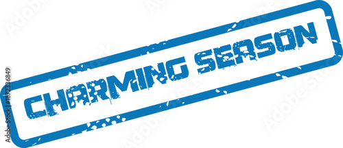 A vibrant blue distressed rubber stamp features the prominent words Charming Season enclosed in a rectangle