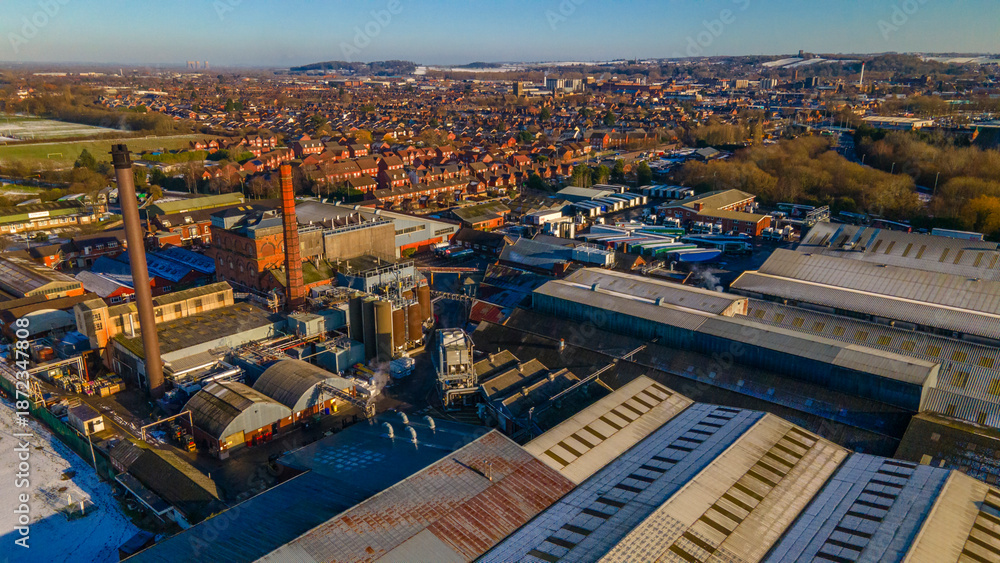 Obraz premium Aerial view of the industrial brewery district and residential houses in winter