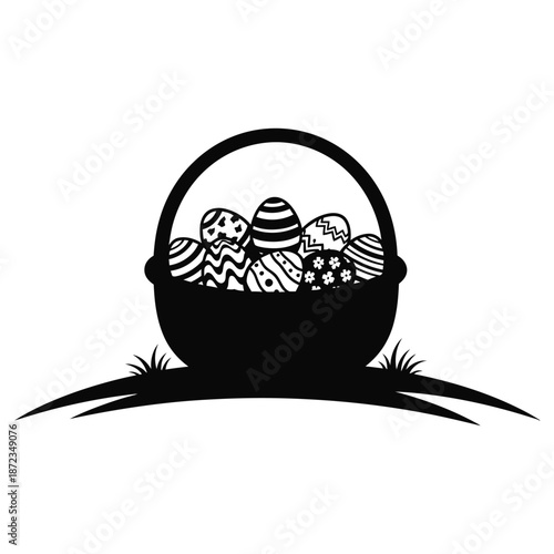 Black silhouette of a basket filled with decorated easter eggs on grass easter day
