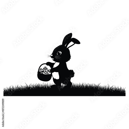 Black silhouette of a cute bunny holding an easter egg on grass easter day