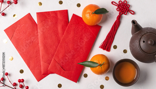 Red envelope lucky money lunar new year chinese new year festival orange tangerine tea decoration celebration joyful flat lay of red envelope
