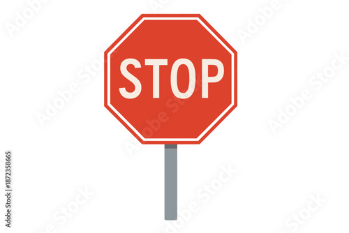 Stop sign on roadside in urban area indicating drivers to halt at intersection