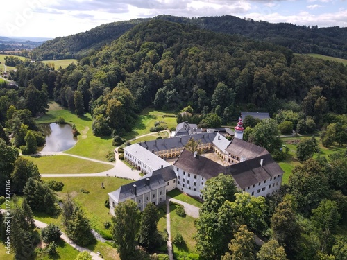 Aerial view of the town of Velké Losiny in the foothills of the Jeseníky Mountains. Drone view of Velké Losiny Castle and the castle garden.