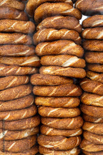 A large stack of fresh simit, Turrkish sesame bread