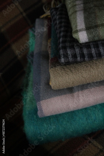 stack of plaid scarves of different colors