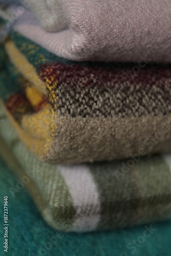 stack of plaid scarves of different colors
