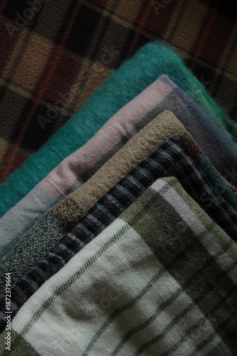 stack of plaid scarves of different colors