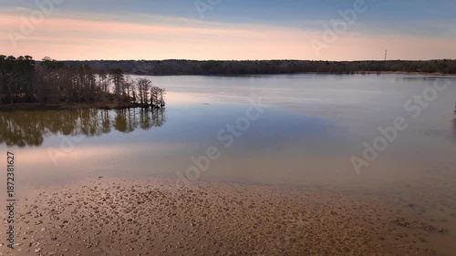 Aerial shot over calm Chickahominy River with marshland and horizon glow, Virginia