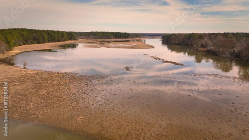 Aerial shot over calm Chickahominy River with marshland and horizon glow, Virginia