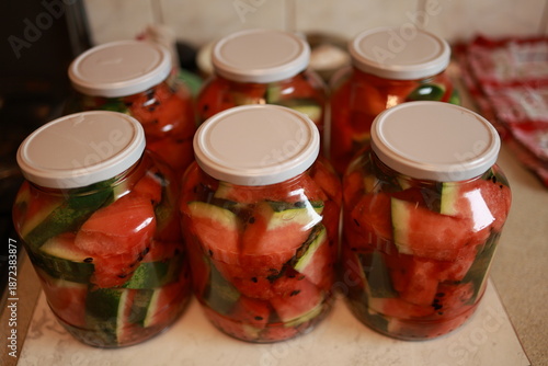 Obraz na plátně Several glass jars with white lids filled with homemade pickled watermelon