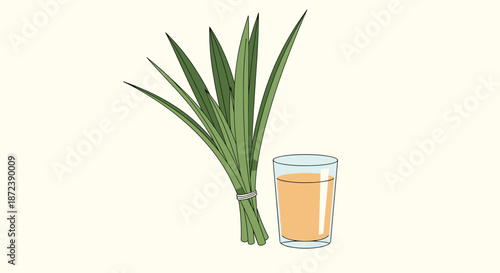 Fresh bundle of long green pandan leaves placed next to a glass of pale orange herbal tea or juice on light background.