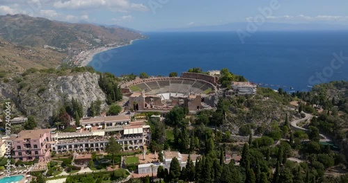 Aerial view of the theater of Taormina, in the province of Messina, Sicily, Italy. These are the ruins of an ancient Greek theater. The Mediterranean Sea extends to the horizon in the background.