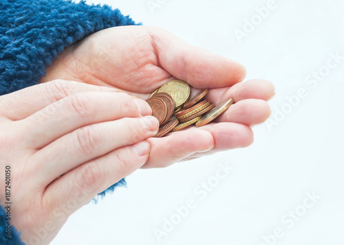 Euro coins in a woman's hands, selective focus.	