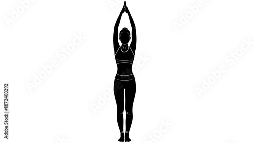 Silhouette of a woman practicing yoga in a serene pose.