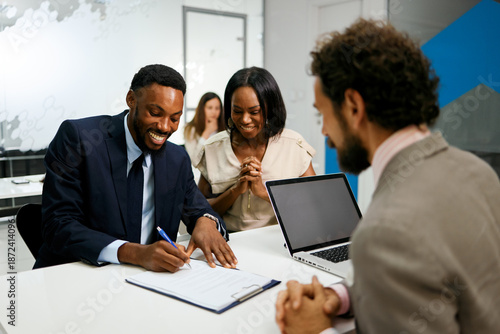 Business people signing contract during a meeting at office