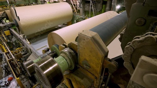 A cardboard production machine. The cardboard comes out of the machine and is wound onto a reel