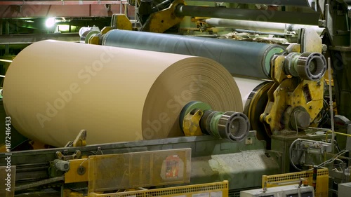A cardboard production machine. The cardboard comes out of the machine and is wound onto a reel
