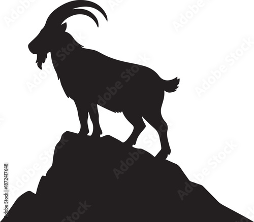 Majestic silhouette of a proud mountain goat standing firmly on a rugged rocky peak