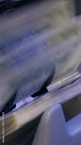 Close up of Cash Counting Machine Processing Banknotes of 100 Dollars