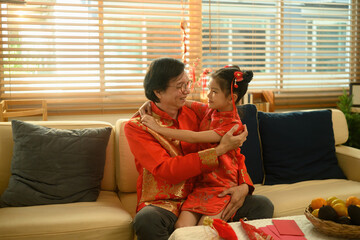 Grandfather and granddaughter share a joyful hug during Chinese New Year moment