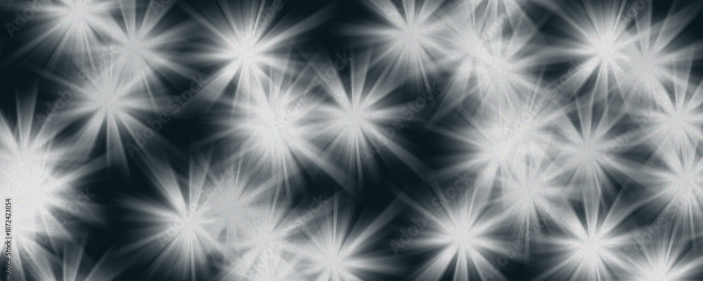 Fototapeta premium Glowing white starburst flares on dark blue background with film grain, celestial light effect or holiday sparkle illustration.