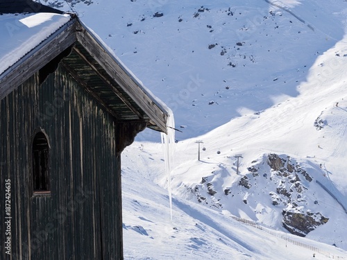 Icicles hanging from the roof of a house in the Sierra Nevada ski resort (Granada, Spain) on a sunny winter morning