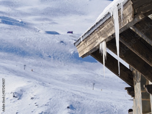 Icicles hanging from the roof of a house in the Sierra Nevada ski resort (Granada, Spain) on a sunny winter morning