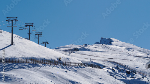 Chairlift at the Sierra Nevada ski resort (Granada, Spain) on a sunny winter morning