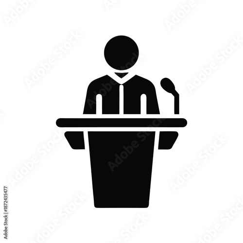 Silhouette of a speaker presenting at a podium with a microphone during a speech