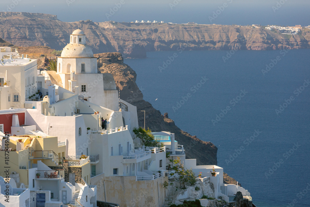 Fototapeta premium White cliffside buildings and churches in Fira, Santorini, Greece
