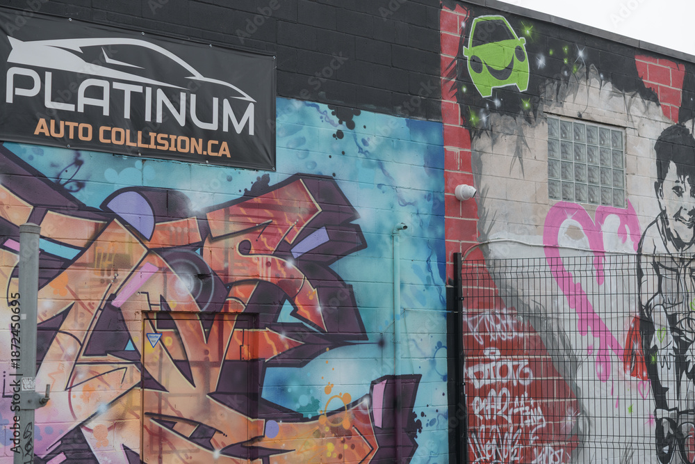 Obraz premium street art at the rear of Platinum Auto Collision, an auto body and collision repair shop located at 2 Cariboo Av in Toronto (shown from Junction Triangle / West Toronto rail area)