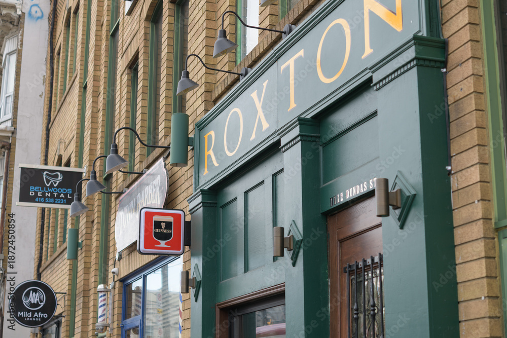Obraz premium exterior building facade and sign of Roxton Public House, located at 1112 Dundas St W, Toronto 