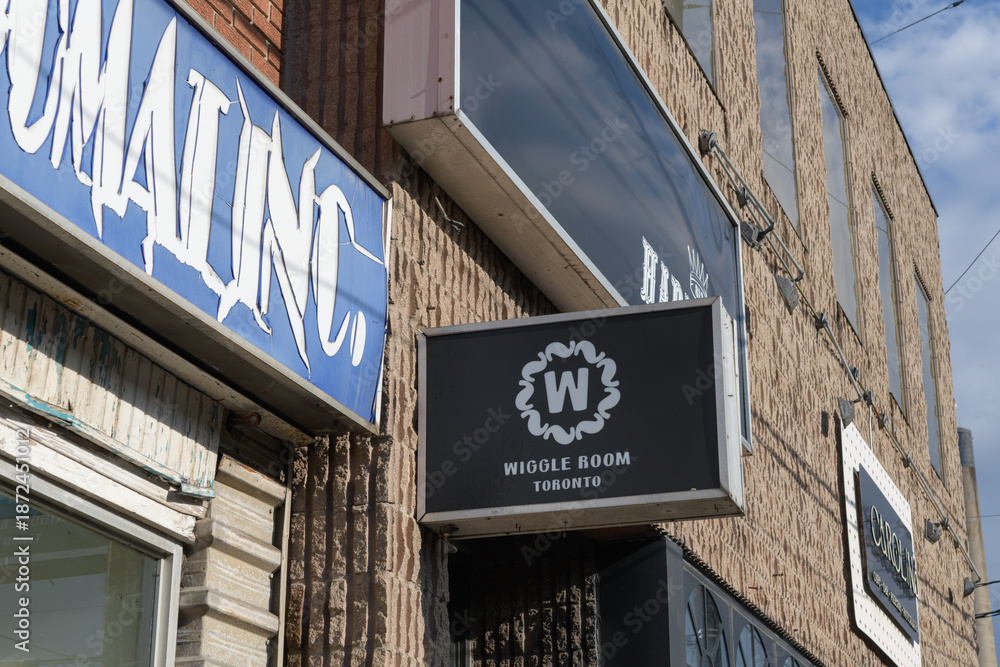 Obraz premium projecting wall sign outside Wiggle Room, Toronto, a late‑night live music, dance and cultural venue at 772 Dundas St W, near Bathurst St