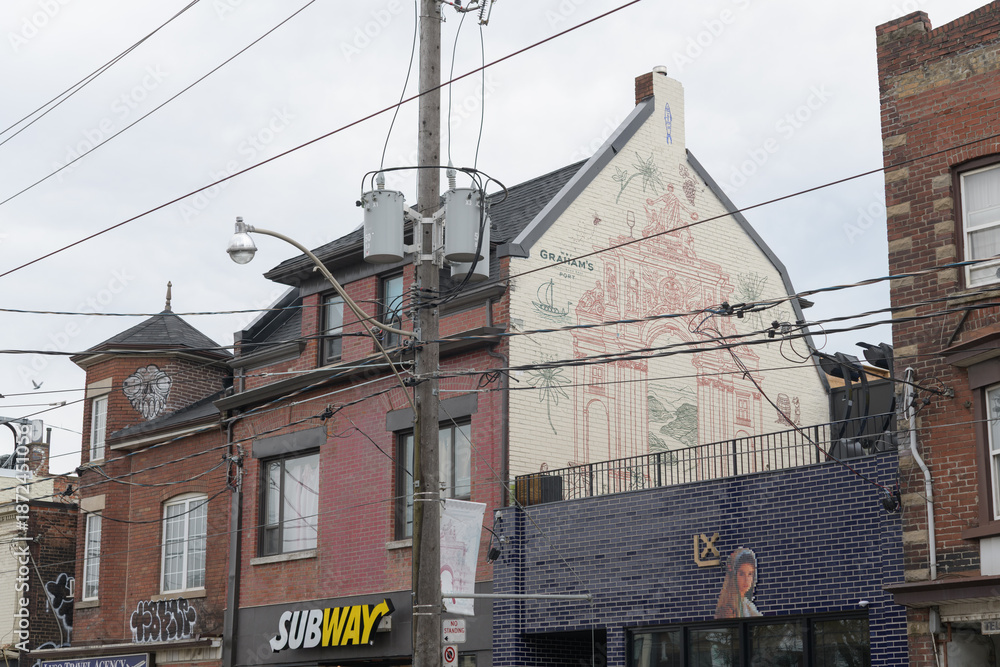Obraz premium exterior buildings and signs of Taberna LX (a restaurant) and Subway (a sandwich shop), located at 1161 and 1159 Dundas St W, Toronto