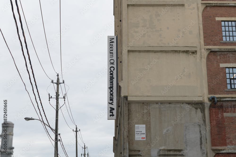 Fototapeta premium exterior projecting sign outside The Museum of Contemporary Art Toronto Canada (MOCA), located at 158 Sterling Rd, a repurposed former automobile manufacturing building