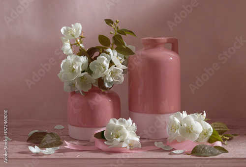 Still life with vases and jasmine in white, pink and green tones