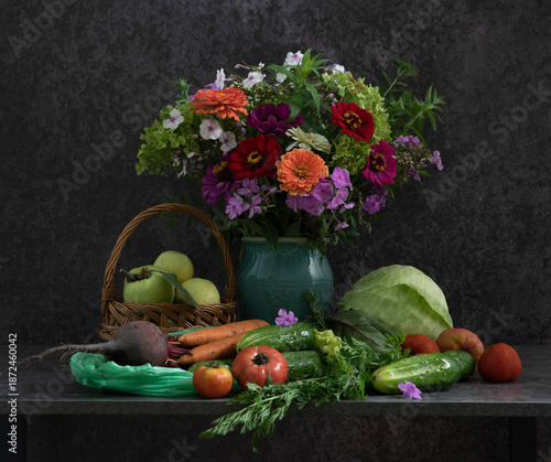 On the table there are vegetables, fruits, ready to eat and prepare tasty and healthy food, and a luxurious bouquet of flowers