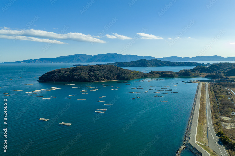 Obraz premium Winter aerial view of a fishing port town and solar panels in Ushimado, Okayama, Japan.